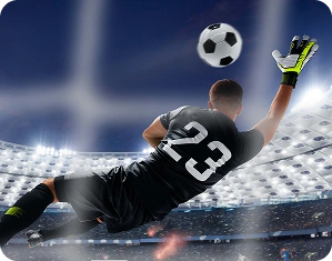 Un gardien de but portant le numéro 23 plonge en plein vol dans un grand stade éclairé pour intercepter le ballon